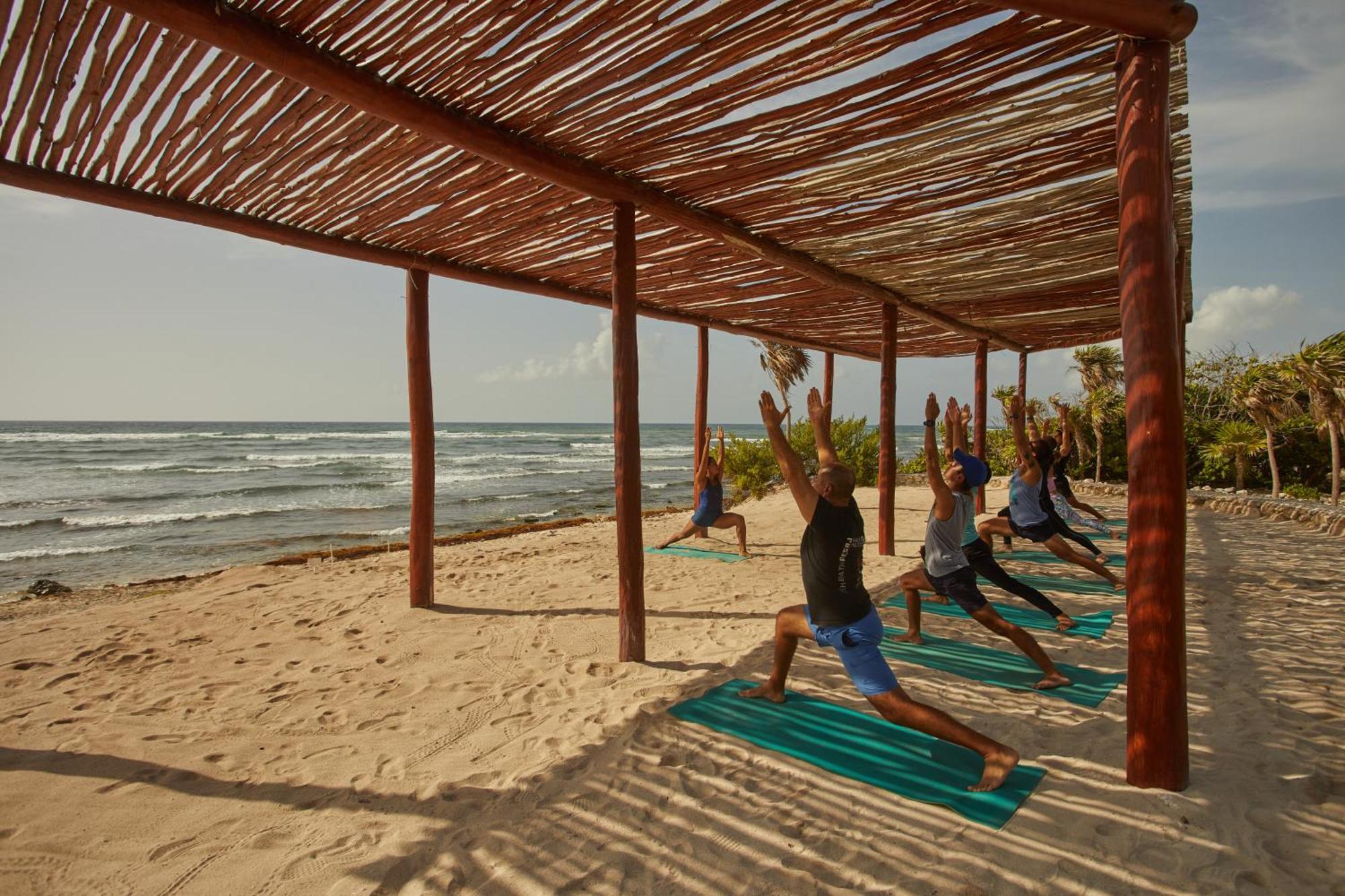 Bahia Principe Grand Tulum Hotel Riviera Maya Exterior photo A yoga class at the beach